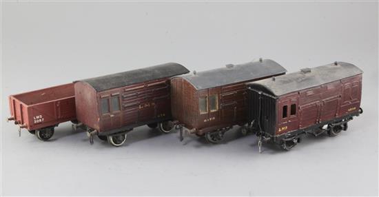 An open wagon, LMS, no.9097, in red, a GWR horse box, no.8173, in red, an LMS horse box, no.456, in red